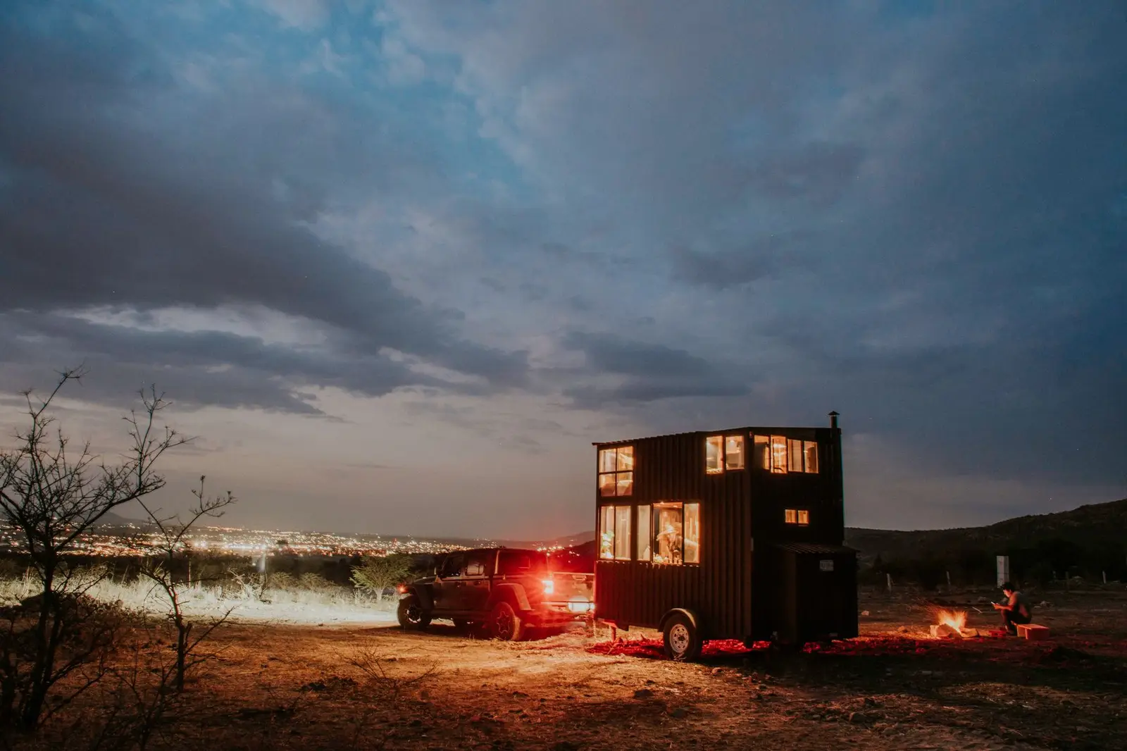 Car and camper set up at dusk